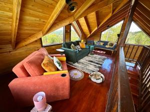 a view of a living room in a tree house at Cabaña Nora Cozy Mountain Cabin & Coffee in Cedral