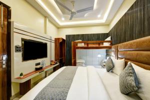 a hotel room with a bed and a flat screen tv at Hotel New Frontier, City Centre - Walk in Chandni Chowk & OLD Delhi Station in New Delhi +101 photos