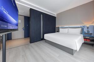 Katil atau katil-katil dalam bilik di Atour Light Hotel Zhuhai Xiangzhou Mingzhu Station