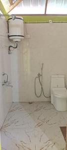 a bathroom with a shower and a toilet at Katus in Gangtok