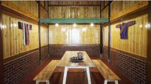 a room with a wooden table and benches in it at Cha Ta Homestay & Trekking Tour Sa Pa in Sa Pa