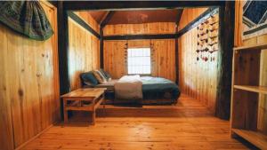 a bedroom with a bed in a wooden room at Cha Ta Homestay & Trekking Tour Sa Pa in Sa Pa