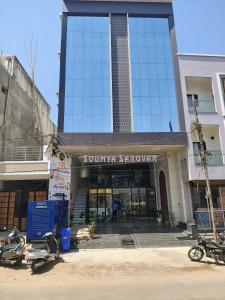 a building with motorcycles parked in front of it at Hotel soumya sarovar in Jagdalpur