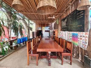 a dining room with a wooden table and chairs at Ratanakiri Homestay & Jungle Trek in Banlung