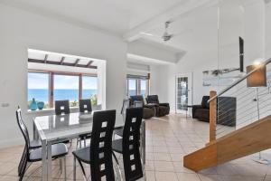 a dining room and living room with a table and chairs at Belle Escapes - Ocean Breeze Family Villa in Somerton Park