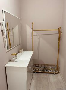 a bathroom with a white counter and a mirror at Уютная 2-х комнатная квартира in Taraz