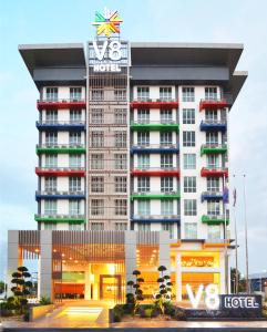 a hotel building with a clock on top of it at V8 Hotel Johor Bahru in Johor Bahru