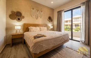 a bedroom with a bed and a large window at Xunik Tulum 205 1BR Condo in Tulum +160 photos
