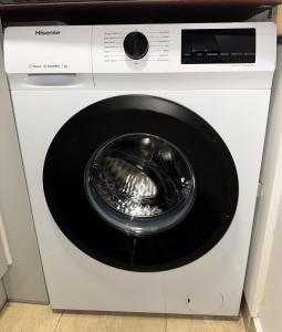a white washing machine with a washer at Queensborough Apartment, Central London in London