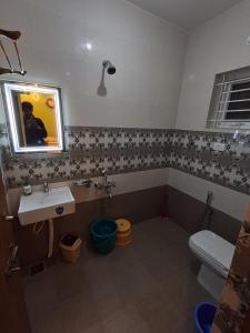 a bathroom with a sink and a toilet at A N S Residency in Ooty