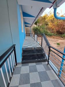 a stairway leading up to a building with a blue wall at A N S Residency in Ooty