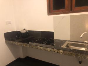 a kitchen with a counter top with a sink at Marine bay surf villa in Weligama