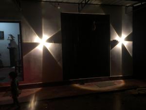 a room with a door and lights on the wall at Marine bay surf villa in Weligama