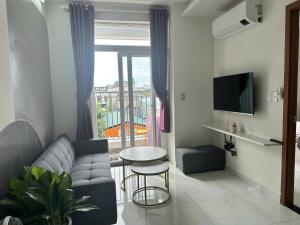 a living room with a couch and a table at DINO Home HACOM 2BR 2WC in Kinh Dinh