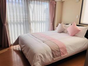 Postel nebo postele na pokoji v ubytování 桜の舞3号馆 Sakura Dance 3