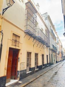 a row of buildings on a city street at La Casita Gaditana in Cádiz