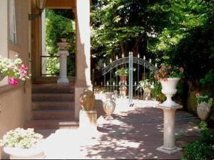 a porch with vases of flowers and a gate at Bastgen Bed & Breakfast in Wittlich