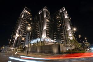 two tall buildings at night with street lights at Brassbell l Sheikh Zayed l Aeon Towers in Cairo
