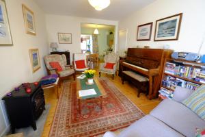 a living room with a couch and a piano at Arkland in Inveraray