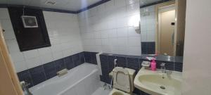 a bathroom with a sink and a toilet and a tub at DOS #FaMiLy RooM AwAy Fr0m HoMe in Abu Dhabi