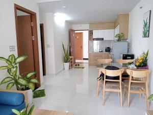 a kitchen and living room with a table and chairs at DINO Home HACOM 2BR 2WC in Kinh Dinh +5 photos