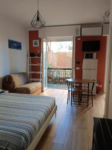 a bedroom with a bed and a table and a room with a balcony at Apartment/Studio il Girasole in Rapallo