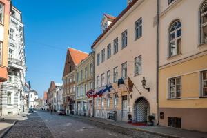 an empty street in a city with buildings at Three Crowns Residents in Tallinn