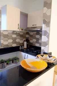 a kitchen with a stove and a plate on the counter at Flic And Flac Apartment 1 in Kampala