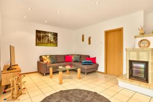 a living room with a couch and a fireplace at Haus Christof in Bodenmais