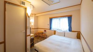 a hotel room with a bed and a window at Toyoko Inn Tokyo Asakusa Kuramae No 1 in Tokyo