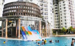 people in a pool with a water park with a water slide at Homestay Bayou Lagoon Resort & Waterpark, Free Access to Waterpark 2 pass in Kampong Bukit Beruang