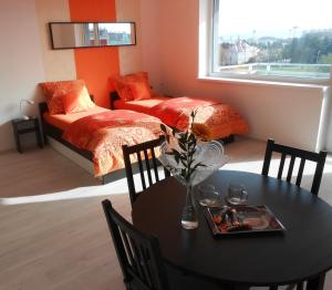 a bedroom with a table and a bed and a table and chairs at Apartments 4U center + free parking in Olomouc