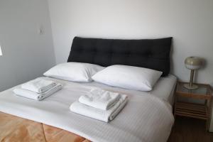 a bed with white towels on top of it at Pistacchio by SnappyB in Alexandroupoli
