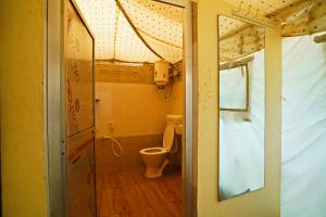 a small bathroom with a toilet in a room at Bubbles of luxury Dublagadi Beach in Sindhia +67 photos