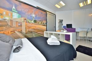 a bedroom with a large painting on the wall at Che Room in Zadar