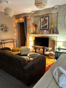 a living room with a couch and a fireplace at La renaissance in Périgueux