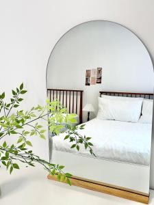a bedroom with a white bed with an archway at Bliss Stay 3mins to Gwangan Station in Busan