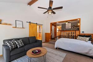 a living room with a bed and a couch at Brother Bear Cabin in Big Bear City +17 photos