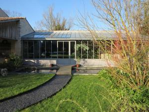 a glass house with a garden in front of it at Le Moulin de la Borderie in Saint-Pierre-dʼOléron +37 photos