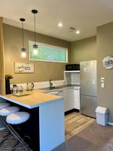 a kitchen with a counter and a refrigerator at 5-Star Boutique Retreat! Hot pool! Amazing view! in Queenstown