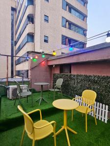 a patio with chairs and tables and lights on a building at Space Stay in Seoul
