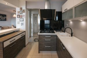 a kitchen with a sink and a stove at Superbia Osijek - SELF CHECK-IN in Osijek