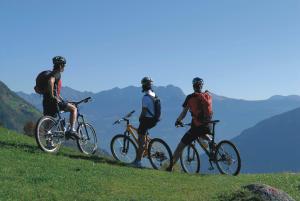 a group of three people riding bikes on a hill at Casa Santa Maria in Folgaria +81 photos