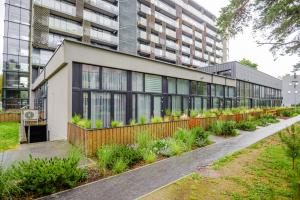 a building with plants on the side of it at Palanga Suites in Palanga