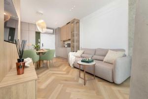 a living room with a couch and a table at Wave Apartments by Solarento in Międzyzdroje