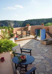 a patio with a table with a bowl of fruit on it at Abramis Rooms in Mitáta