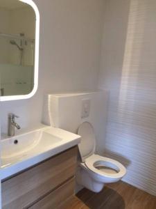 a white bathroom with a sink and a toilet at Villa MA&VA in Lacanau-Océan