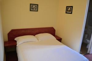 Un pat sau paturi într-o cameră la Grand Hotel De La Gare