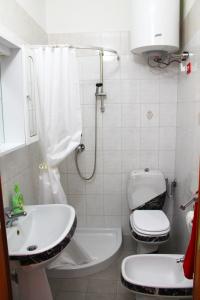 a bathroom with a toilet and a sink at Ariel Apartment Ortigia Siracusa in Siracusa