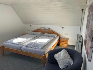 a bedroom with a large bed and a chair at Ferien- und Reiterhof Bareth in Argenbühl